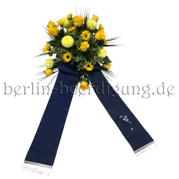 Blumen zur Beerdigung in warmen Gelb mit blauer Schleife