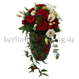 Eine schmal und elegant gearbeitete Urnenkrone aus dunkelroten Rosen und weißen Lysianthus-Blüten.